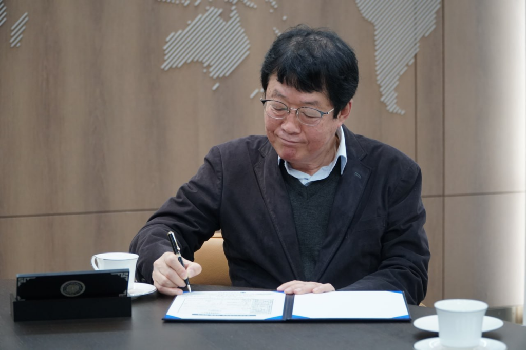 기부약정서에 서명하는 김종찬 회장
